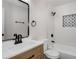 Modern bathroom with a sleek, black framed mirror and updated sink and faucet at 2358 Larchwood Sw Rd, Atlanta, GA 30310