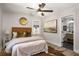 Bedroom featuring wood floors, ceiling fan, en suite bathroom, and views of outside at 2358 Larchwood Sw Rd, Atlanta, GA 30310