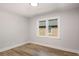 Bedroom with wood floors and neutral paint and a large window at 2358 Larchwood Sw Rd, Atlanta, GA 30310