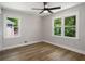 Bedroom featuring hardwood floors, neutral walls, and natural light from two large windows at 2358 Larchwood Sw Rd, Atlanta, GA 30310