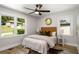 Cozy bedroom with a ceiling fan, two windows, and wood-look flooring at 2358 Larchwood Sw Rd, Atlanta, GA 30310