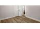 Bright bedroom features luxury vinyl plank flooring and double door closet for ample storage at 2358 Larchwood Sw Rd, Atlanta, GA 30310