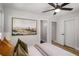 Comfortable bedroom featuring wood floors, a ceiling fan, and a spacious closet at 2358 Larchwood Sw Rd, Atlanta, GA 30310