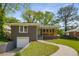 Charming brick home featuring a covered front porch, nicely landscaped lawn, and attached garage at 2358 Larchwood Sw Rd, Atlanta, GA 30310
