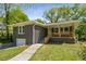 Charming brick home with inviting covered porch and a well-maintained lawn at 2358 Larchwood Sw Rd, Atlanta, GA 30310
