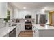 Stylish kitchen featuring stainless steel appliances, white cabinets, and elegant countertops at 2358 Larchwood Sw Rd, Atlanta, GA 30310