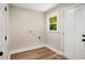 Bright laundry room with hardwood floors, neutral walls, and a window at 2358 Larchwood Sw Rd, Atlanta, GA 30310