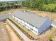 New townhome construction showcasing rear elevations with landscaped yards and scenic surroundings at 2405 Malster Ln, Lawrenceville, GA 30043