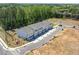 An aerial view of newly constructed townhomes, set against a lush, green backdrop at 2405 Malster Ln, Lawrenceville, GA 30043