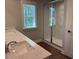 Bathroom featuring double sinks, quartz countertop, and large glass-enclosed shower at 2405 Malster Ln, Lawrenceville, GA 30043