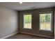 Bright bedroom with carpet, featuring two windows for plenty of natural light at 2405 Malster Ln, Lawrenceville, GA 30043