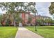 Classic brick building with a manicured lawn and tree-lined path, offering a welcoming community space at 2405 Malster Ln, Lawrenceville, GA 30043