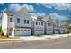 Charming new townhome exteriors featuring brick accents, garages, and well-manicured landscaping at 2405 Malster Ln, Lawrenceville, GA 30043