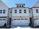 Charming home featuring a wide two-car garage and classic architectural details at 2405 Malster Ln, Lawrenceville, GA 30043