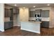 Open kitchen layout with grey cabinets, stainless steel appliances, and granite countertops at 2405 Malster Ln, Lawrenceville, GA 30043