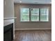 Bright living room featuring large windows and modern fireplace with a white mantle at 2405 Malster Ln, Lawrenceville, GA 30043