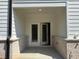 Covered outdoor patio space, perfect for relaxing and entertaining, with double doors at 2405 Malster Ln, Lawrenceville, GA 30043