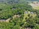 Panoramic aerial view of a home and neighborhood featuring mature trees and beautiful landscaping at 675 Jack Page Ln, Canton, GA 30115