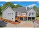 Backyard view of home with deck, stairs, and covered patio area for entertaining at 675 Jack Page Ln, Canton, GA 30115