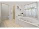 Bright bathroom featuring a soaking tub, gold hardware, and separate shower at 675 Jack Page Ln, Canton, GA 30115