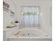 Bathroom featuring a bright soaking tub, gold hardware, and neutral accents at 675 Jack Page Ln, Canton, GA 30115