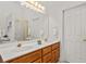 Bright bathroom with dual sinks, wood cabinets, and gold hardware at 675 Jack Page Ln, Canton, GA 30115