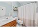 Bathroom featuring a single sink vanity, decorative shelves, and shower with a curtain at 675 Jack Page Ln, Canton, GA 30115