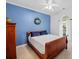 Comfortable bedroom with a bright blue accent wall and a classic wood bed at 675 Jack Page Ln, Canton, GA 30115
