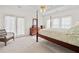Bedroom featuring a four-poster bed, with large windows and a dresser at 675 Jack Page Ln, Canton, GA 30115