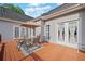 View of the deck furnished with a table, chairs, and an umbrella with access to the house at 675 Jack Page Ln, Canton, GA 30115