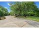 Long driveway surrounded by lush landscaping and mature trees on a sunny day at 675 Jack Page Ln, Canton, GA 30115