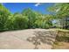 Wide driveway on a sprawling lot with mature shade trees at 675 Jack Page Ln, Canton, GA 30115