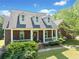 Charming brick home features a welcoming front porch and well-maintained landscaping at 675 Jack Page Ln, Canton, GA 30115