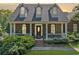 Charming brick home features a welcoming front porch and well-maintained landscaping at 675 Jack Page Ln, Canton, GA 30115