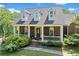Charming brick home features a welcoming front porch and well-maintained landscaping at 675 Jack Page Ln, Canton, GA 30115