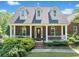 Charming brick home features a welcoming front porch and well-maintained landscaping at 675 Jack Page Ln, Canton, GA 30115
