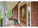 Inviting front porch with a wooden door and glass window at 675 Jack Page Ln, Canton, GA 30115