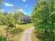 Charming home with a long driveway, lush lawn, and mature trees at 675 Jack Page Ln, Canton, GA 30115