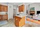 Kitchen featuring an island, tile flooring, white countertops and a view into the living room at 675 Jack Page Ln, Canton, GA 30115