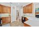 Kitchen showcasing oak cabinets, tile flooring, white countertops, and stainless steel dishwasher at 675 Jack Page Ln, Canton, GA 30115