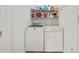 Functional laundry room with a washer, dryer, and overhead storage shelf at 675 Jack Page Ln, Canton, GA 30115