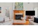 Living room showcasing a wood fireplace with stone hearth, mantle and decorative painting above at 675 Jack Page Ln, Canton, GA 30115