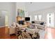 Bright living room featuring a fireplace, hardwood floors, and large windows with lots of natural light at 675 Jack Page Ln, Canton, GA 30115