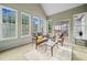 Bright sunroom with many windows, comfortable seating and access to the backyard at 675 Jack Page Ln, Canton, GA 30115