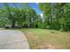 Spacious yard with mature trees, picnic table, and flagpole at 675 Jack Page Ln, Canton, GA 30115