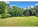 Lush green lawn with mature trees and landscaping at 675 Jack Page Ln, Canton, GA 30115