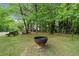 Spacious yard featuring mature trees, picnic tables, and a fire pit at 675 Jack Page Ln, Canton, GA 30115