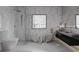 Modern bathroom with marble walls, freestanding tub, and sleek fixtures at 995 Sw Sparks St, Atlanta, GA 30310