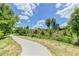Scenic walking path surrounded by lush greenery and trees under a bright blue sky at 995 Sw Sparks St, Atlanta, GA 30310