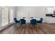 Contemporary dining area with a white table, blue chairs, and access to outdoor space at 1025 Cherryfield Run, Marietta, GA 30008